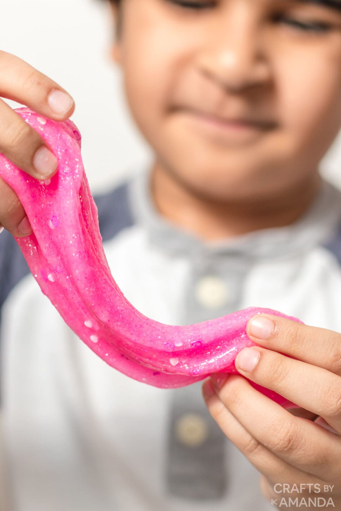 child holding pink valentine slime