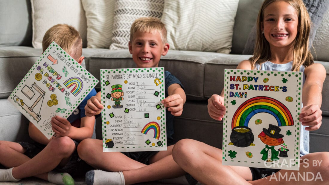 children holding up St. Patrick's Day Activity Sheets 