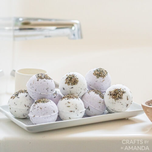 lavender bath bombs on a tray by the tub