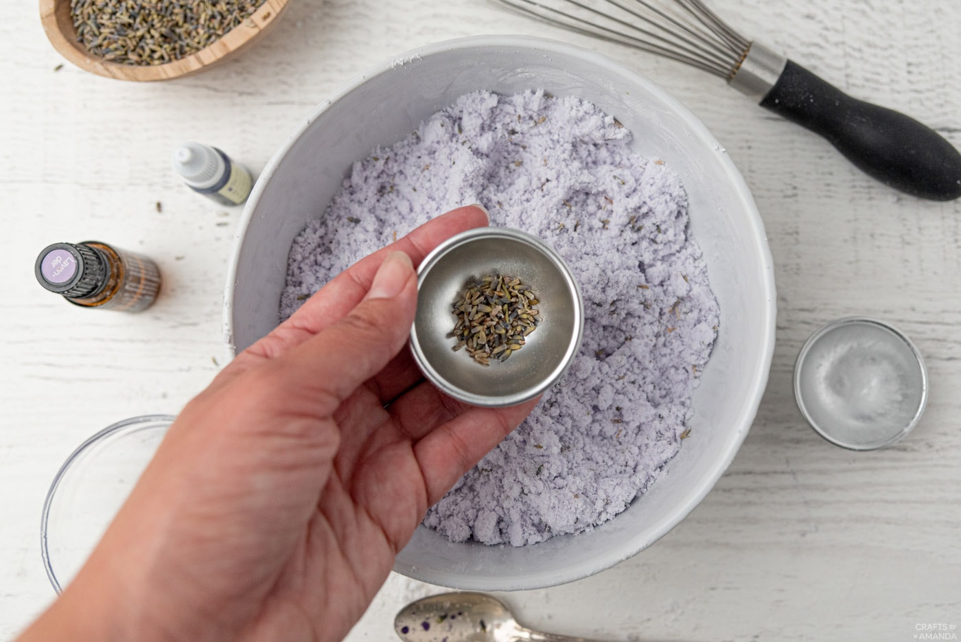 adding dried lavender buds to bottom of mold
