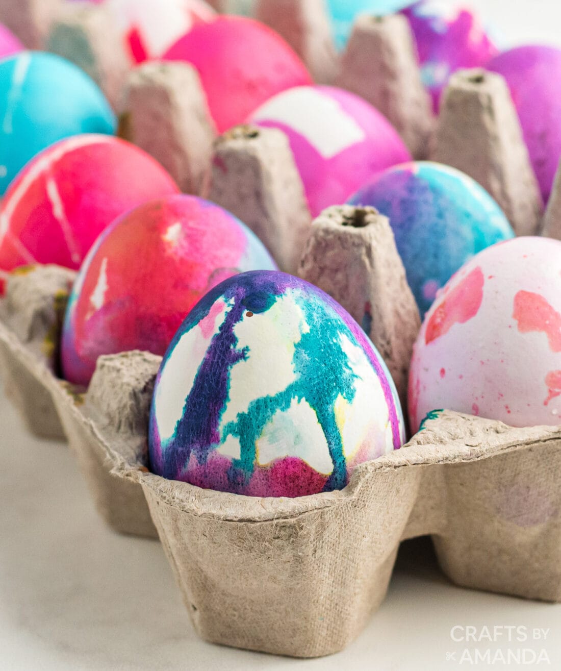 decorated easter eggs in egg carton