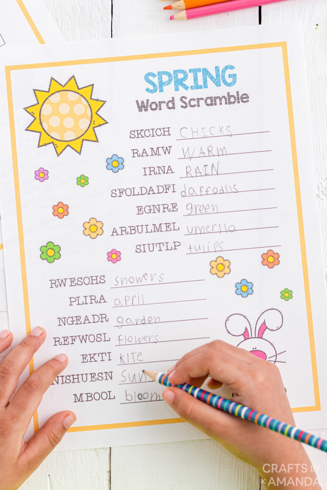 child filling in word scramble