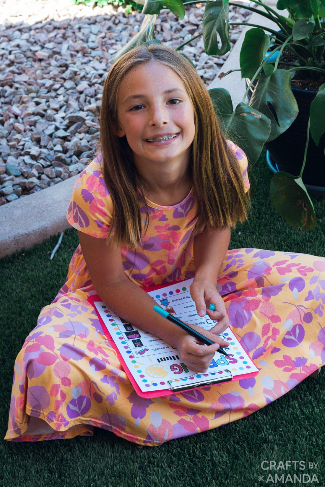 girl smiling while doing Spring Scavenger Hunt