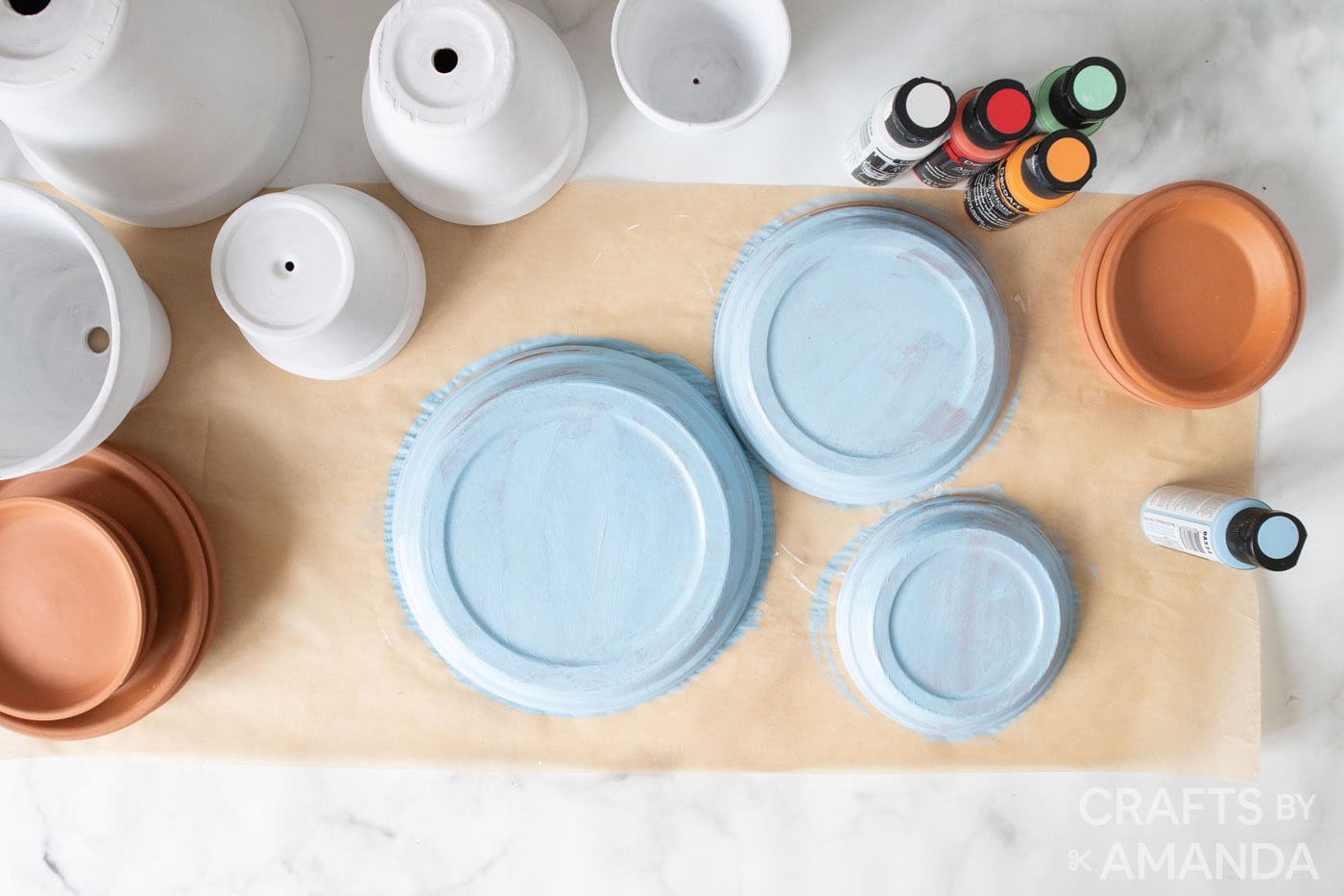 painting terracotta saucers in light blue