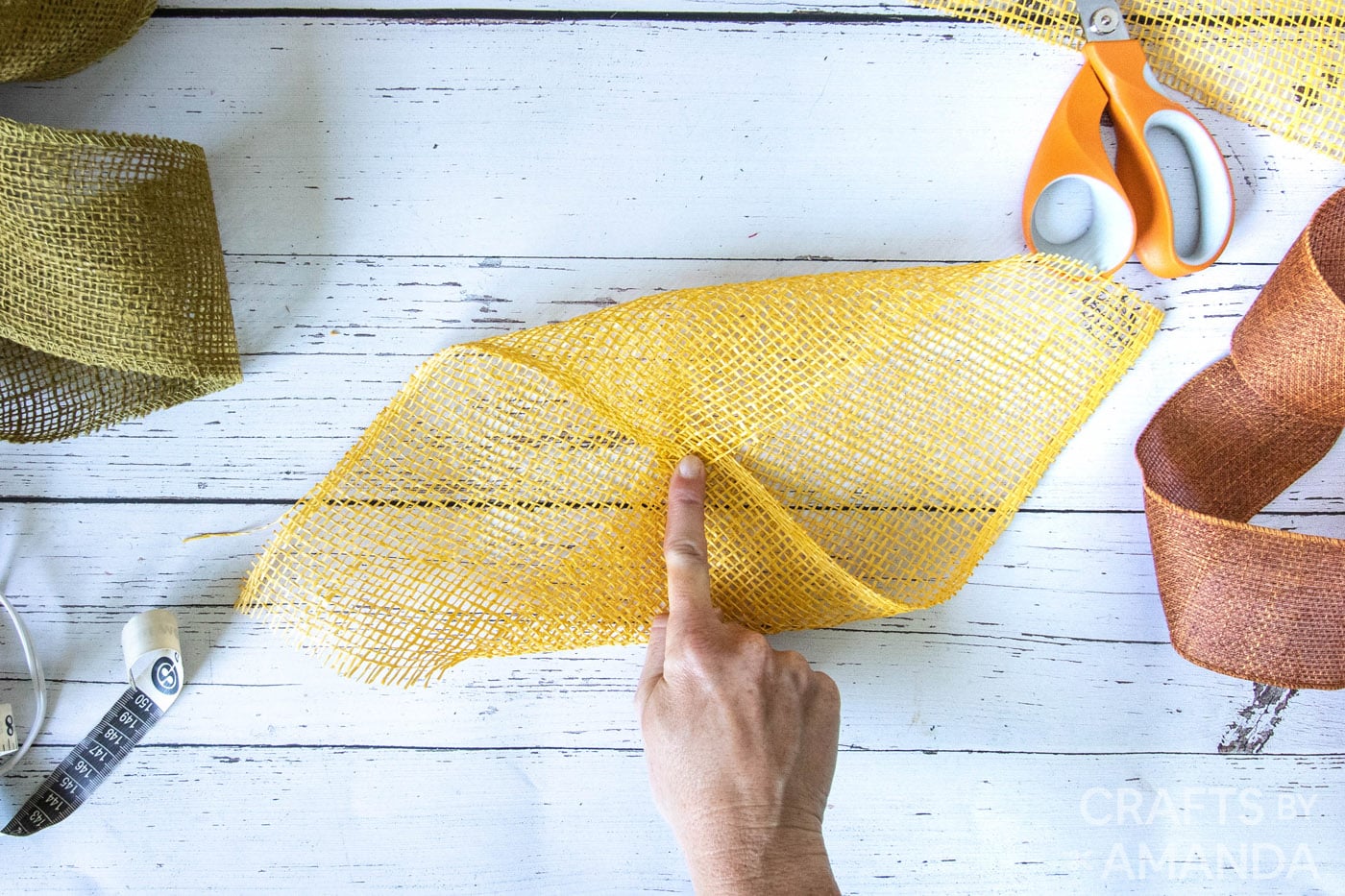 Folding yellow burlap in half