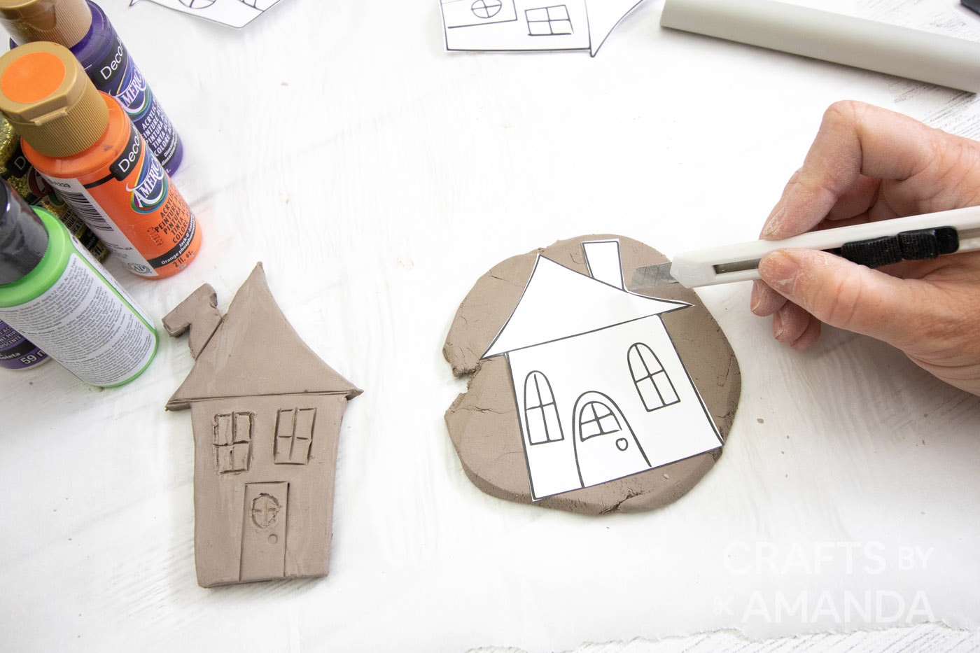 tracing house template on clay
