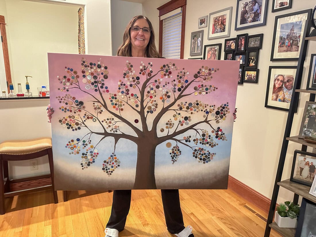 me holding my button tree canvas